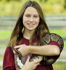 Girl holding a green snake